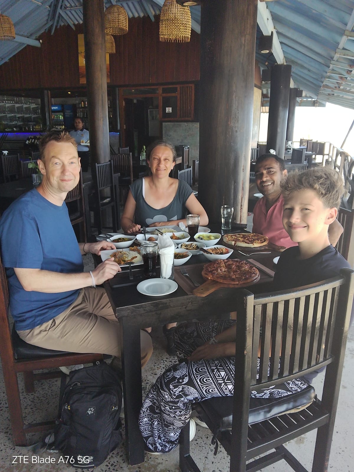 Walter with travelers on a beachside restaurent
